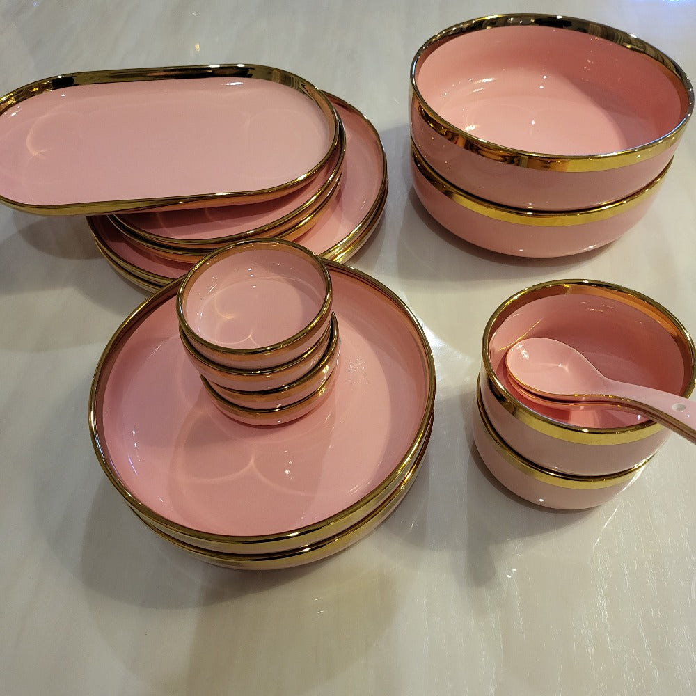 Ceramic dinner set with golden lining in pink plates and bowls